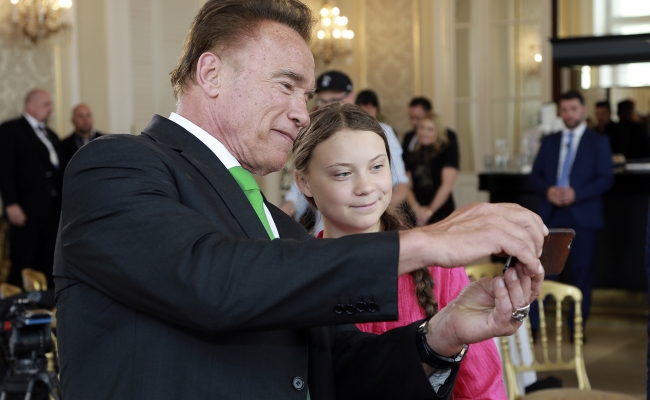 Governor Arnold Schwarzenegger takes a selfie with environmental activist Greta Thunberg.