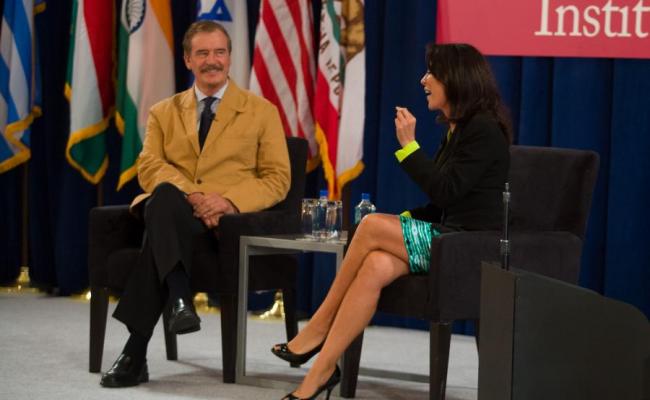 President Fox discussing immigration reform with Gabriela Teissier